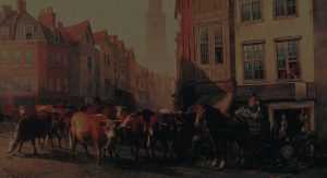 A herd of cows and horses pass through a busy, narrow street lined with old buildings; people watch from windows and doorways as sunlight illuminates the scene, and a church tower is visible in the background.