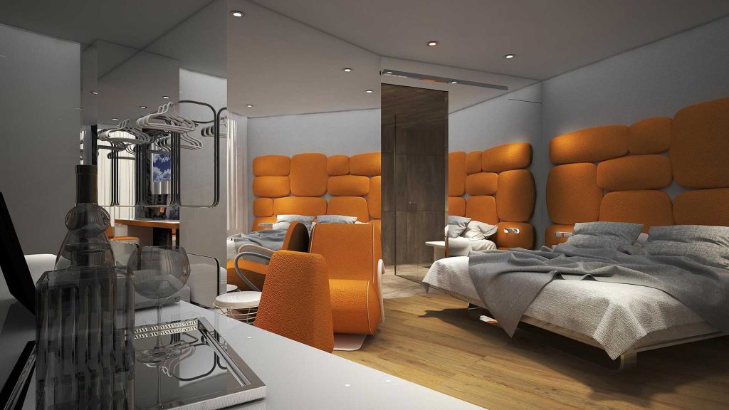 Modern hotel room with unique orange padded walls and headboards, two unmade beds, orange chairs, a wood floor, a mirrored wall, and a desk with glasses, a wine bottle, and water on a tray in the foreground.