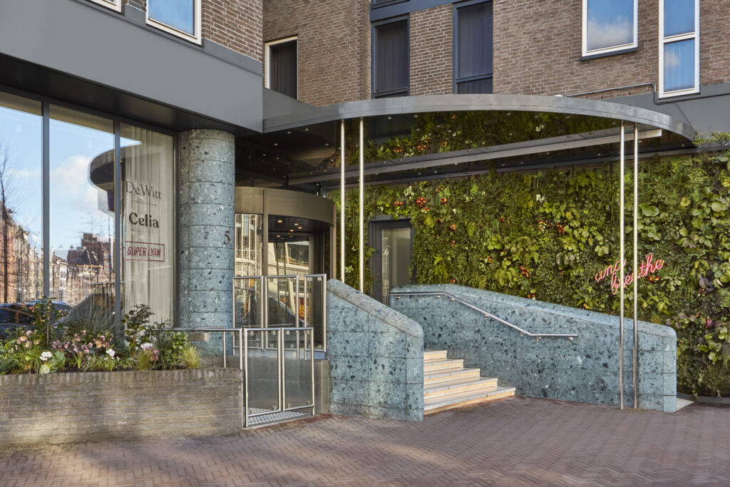 Kimpton de Witt step-free entrance with revolving door alongside the platform lift, vertical living wall of mixed planting with neon ‘and breathe’ signage to the side
Lobby and public areas.