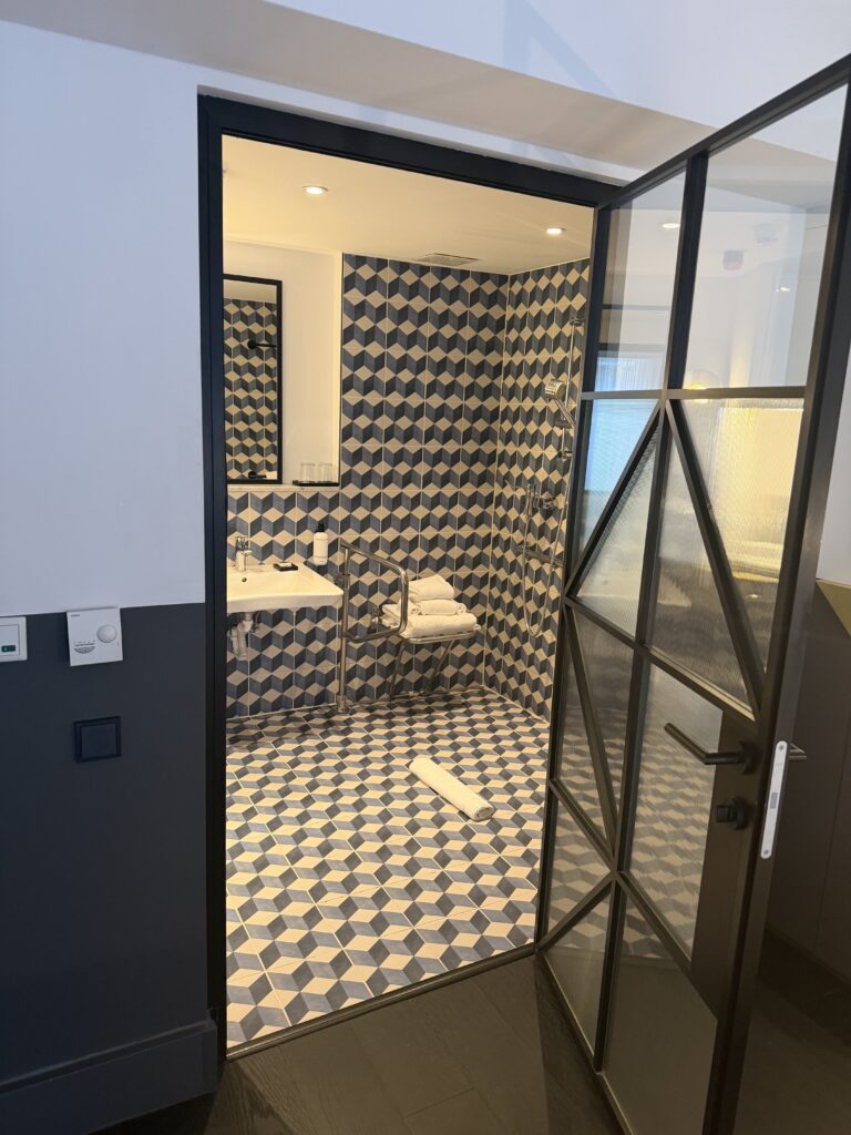 Accessible bathroom doorway with flush threshold between bedroom floor and bathroom tile.