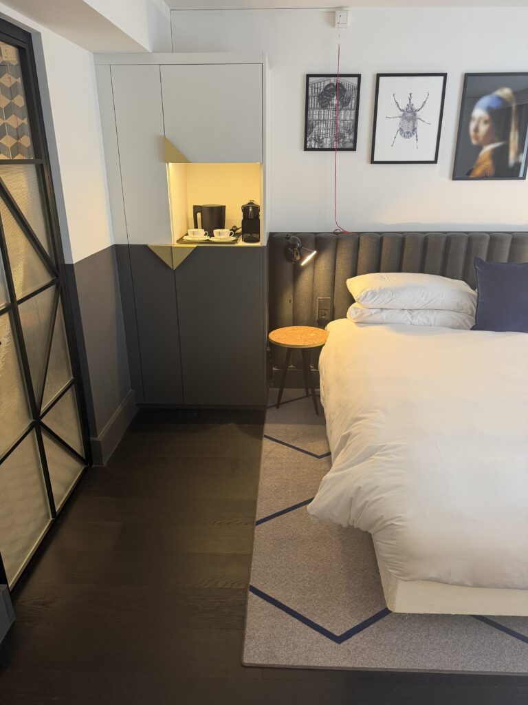 Accessible bedroom showing floor space alongside the bed, with wardrobe and tea station opposite.