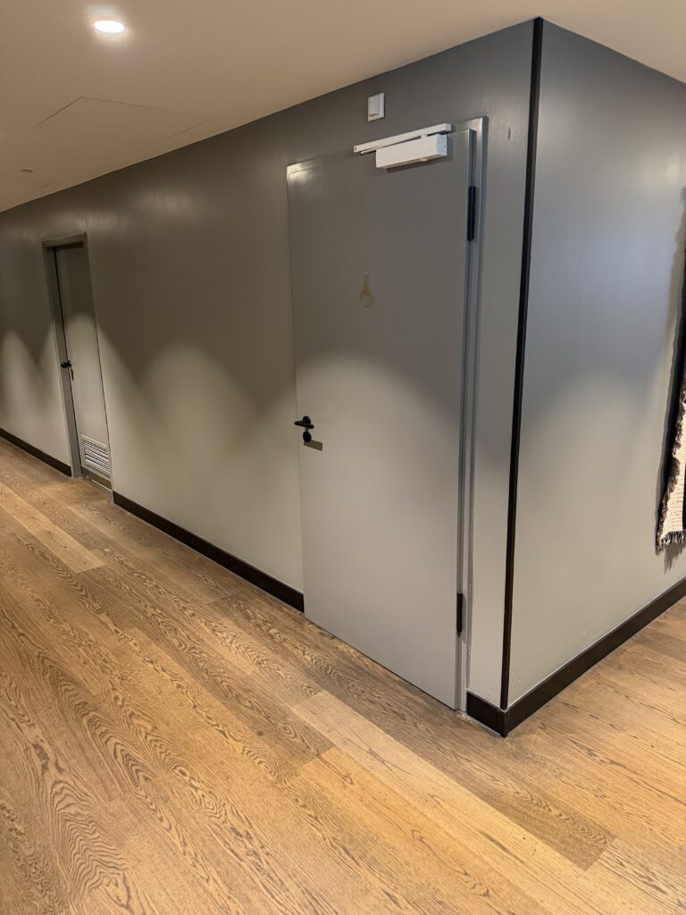 Corridor route to accessible public toilet door.