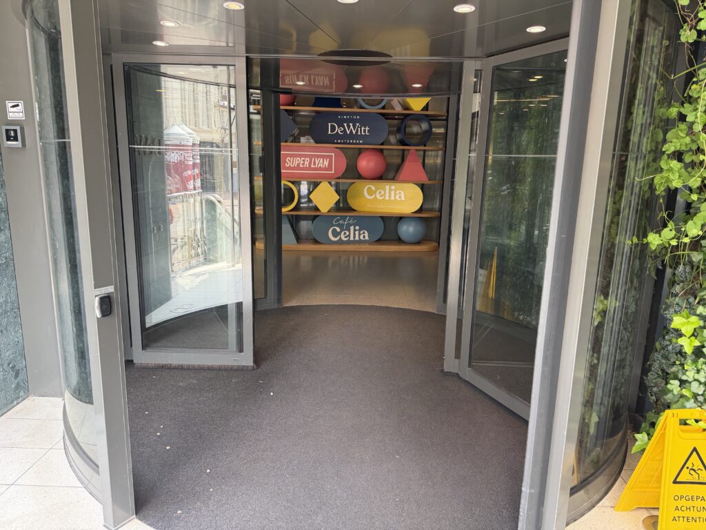 Hotel main entrance revolving door with level threshold at street level.