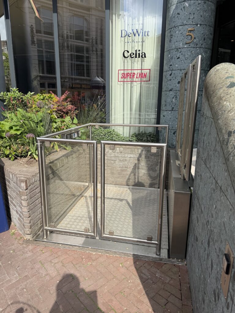 Exterior platform lift at hotel entrance providing step-free access from street.