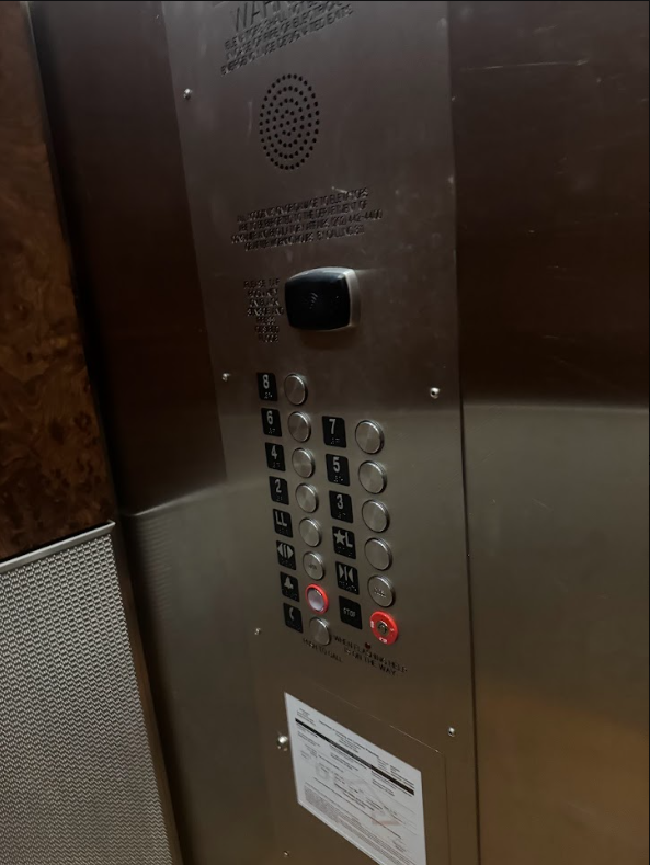 Lift control panel at Lyle Washington DC. Floor buttons with Braille markings beside each, tactile floor indicators, alarm and call controls at the base.